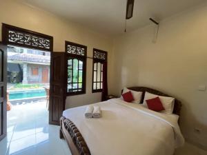a bedroom with a bed and a swimming pool at Gusti Home Stay Ubud in Ubud