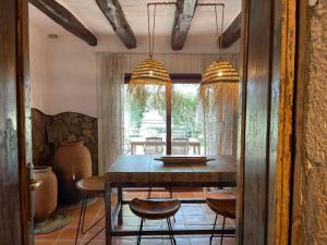 a dining room with a table and some chairs at Más Figueres in Caldes de Malavella +43 photos