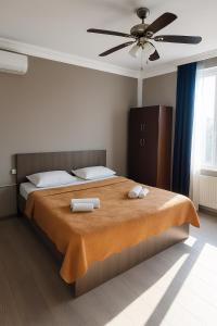 a bedroom with a bed with two towels on it at VILLA SABA WITH TWO BEDROOMS- სასტუმრო საბა in Mtskheta