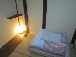Postel nebo postele na pokoji v ubytování Taito Ryokan