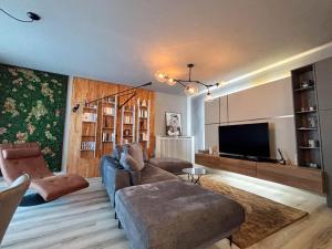 克卢日-纳波卡Sunflower Luxury Haven by Iulius Mall and FSEGA的客厅里有一张沙发和一台电视