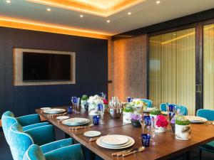 a long table in a room with blue chairs at Sofitel Luxembourg Le Grand Ducal in Luxembourg