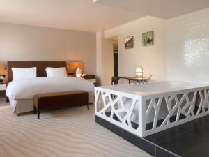 a hotel room with a bed and a tub in it at Sofitel Luxembourg Le Grand Ducal in Luxembourg