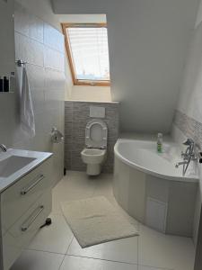 トルナヴァにあるSaint Michael - Garni Hotelの浴槽、トイレ、洗面台を備えたバスルーム