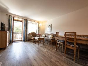 a living room with a couch and a table at FEWO Geierhos in Steibis