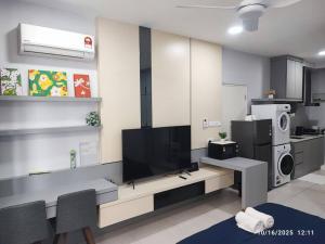 sala de estar con TV y cocina en The Cozy Grey Riverine Diamond, en Kuching