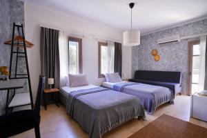 a living room with two beds and a couch at Kalkan Ayapa Hotel in Kaş +78 photos