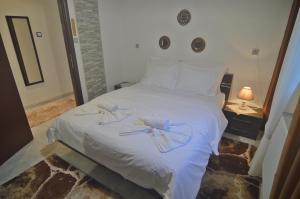 Ένα ή περισσότερα κρεβάτια σε δωμάτιο στο Dimitras Kalithea