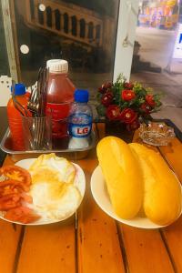 two plates of breakfast food on a wooden table at Phuong Linh Hotel in Bảo Lạc +52 photos
