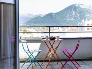 two chairs and a table on a balcony with a view at Aparthotel Adagio Annecy Centre in Annecy +72 photos