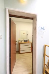 an open door leading into a room with a desk at Quinta das Conchas Apartment by Trip2Portugal in Lisbon