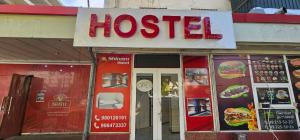 a hospital sign on the front of a restaurant at Shinam Hostel in Chilanzar