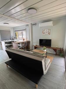a living room with a couch and a table at Salty studio apt Santa Teresa center in Santa Teresa Beach