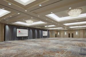 a large room with a stage and two screens at Marriott Downtown at CF Toronto Eaton Centre in Toronto +67 photos