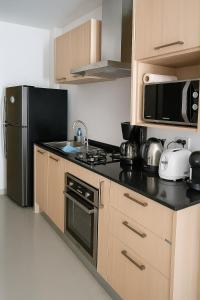 Kuchyň nebo kuchyňský kout v ubytování Appartement 2 Chambres Tropical Sûr et Économique