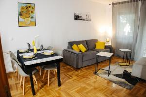a living room with a table and a couch at Apartman Todi & Dana in Sombor