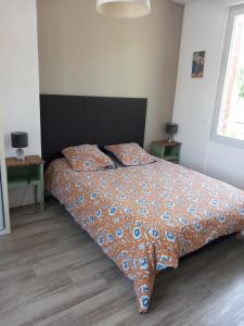 una camera da letto con un letto con un piumone e due cuscini di L'Avre de Roye a Roye Altre 6 foto