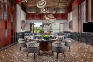 a dining room with a table and chairs at Renaissance Hangzhou Lin'an Hotel in Hangzhou