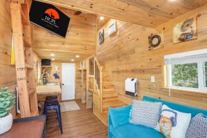 a log cabin living room with a blue couch at Arbor House of Dripping Springs - Harmony Hollow in Dripping Springs