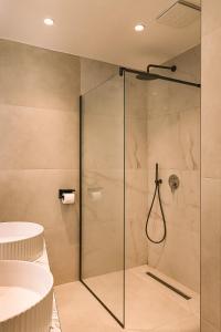 a shower with a glass door in a bathroom at Azure Escape luxury apartments Sarande in Sarandë