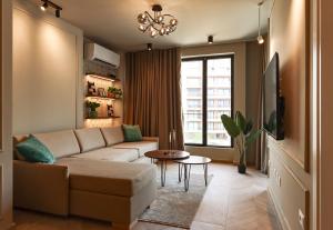 a living room with a couch and a table at Azure Escape luxury apartments Sarande in Sarandë