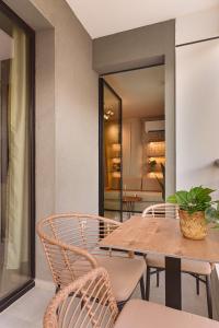a dining room with a table and chairs at Azure Escape luxury apartments Sarande in Sarandë