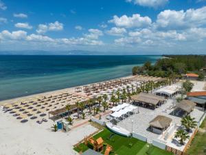 an aerial view of a beach with umbrellas and the ocean at ALEA Hotel & Suites in Prinos