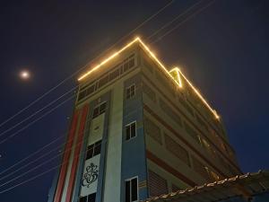 a building with lights on top of it at night at Hotel RPR grand in Narasaraopet