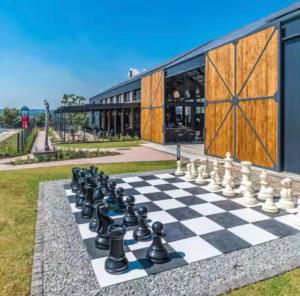 a chess board on a lawn in front of a building at Your Perfect home-away-from -home Retreat in Sandton