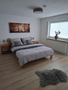 a bedroom with a large bed and a window at Ferienhaus Weitblick in Olsberg