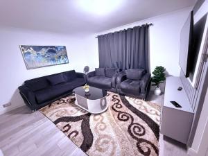 a living room with a couch and a tv at Beautiful and Spacious 1 Bedroom Apartment in Erith