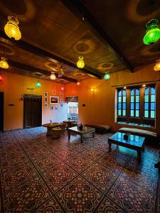 a large room with tables in the middle of it at Marwar Mosaic Heritage Haveli in Jodhpur