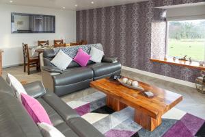 a living room with a couch and a coffee table at Sunset View in Innellan