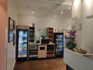 a grocery store with a drink cooler and a refrigerator at Garner Hotel Wiesbaden City by IHG in Wiesbaden