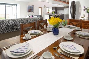 a dining room and living room with a table and chairs at Sunset View in Innellan