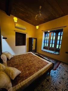 a bedroom with a large bed in a room at Marwar Mosaic Heritage Haveli in Jodhpur
