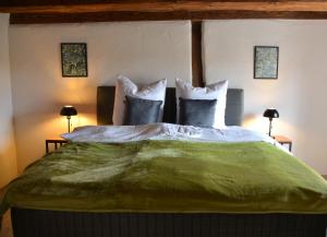 a bedroom with a large green bed with pillows at Ferienhaus mit 2 Schlafzimmern in Grimma nahe Mulderadweg in Grimma