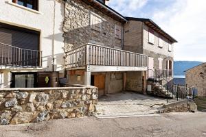 a stone building with a balcony on the side of it at Maison de village Ramballade in Les Angles