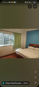 een slaapkamer met een bed en een raam bij Italay in Krabi town