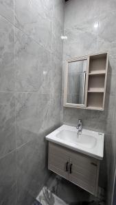 a bathroom with a sink and a mirror at MH villa & hotel in Pancor