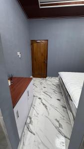a bedroom with a bed and a marble floor at MH villa & hotel in Pancor