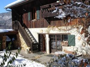 a house with a green door in the snow at La Mutelline - Les Carroz in Arâches-la-Frasse