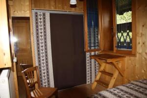 a door in a room with a table and a chair at La Mutelline - Les Carroz in Arâches-la-Frasse