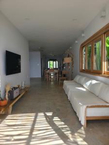 a living room with a white couch and a table at Villa Biển Vàng Beach Front in Bình Sum