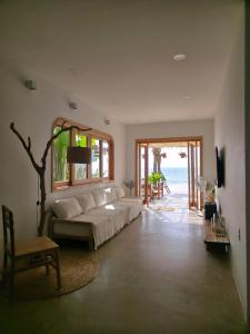 a living room with a white couch and a window at Villa Biển Vàng Beach Front in Bình Sum