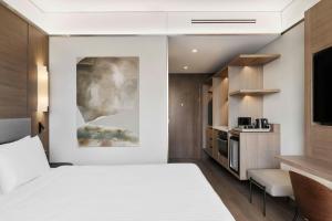 a hotel room with a bed and a kitchen at AC Hotel by Marriott Vilnius in Vilnius +52 photos