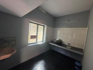 a bathroom with a sink and a window at ROB'S INN Groupstay 