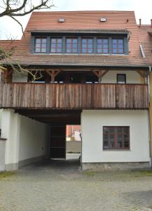 a house with a wooden deck on top of it at Ferienhaus mit 2 Schlafzimmern in Grimma nahe Mulderadweg in Grimma