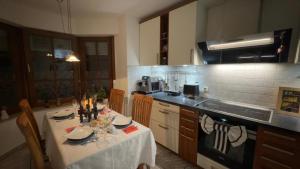 a kitchen with a table with a white table cloth at Gabriel in Sankt Augustin