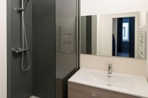 a bathroom with a sink and a mirror at Studio Miribel in Miribel